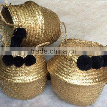 High quality best selling eco-friendly Metallic Gold seagrass baskets with black pompoms from Vietnam