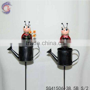 Iron garden stakes of metal beetle standing on kettle sticks for garden decoration