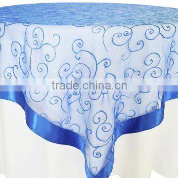 Blue embroidered square table overlay with satin border for weddings