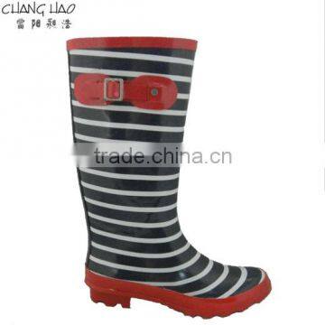 Women fashion rubber rain boot has black and white stripes printed with red buckle and sole