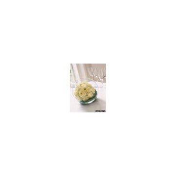 a table centerpiece,a round glass vase filled with roses
