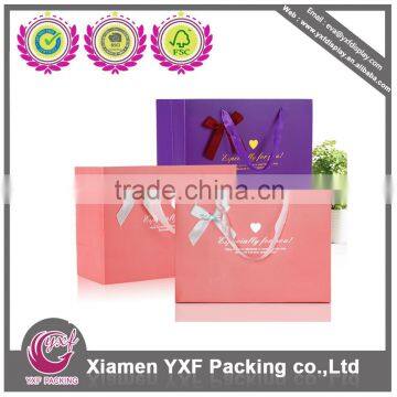 Pink paper bag with ribbon decoration