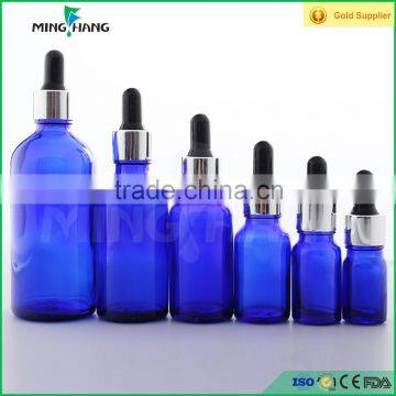 blue essential oil glass bottle with silver dropper