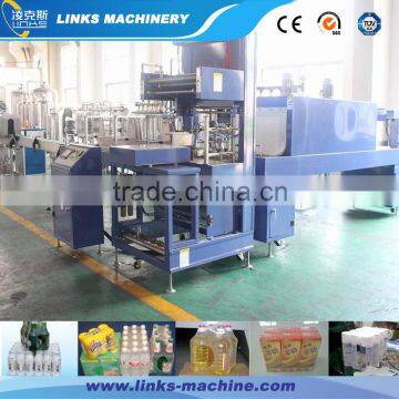 Automatic shrink film wrapping machine