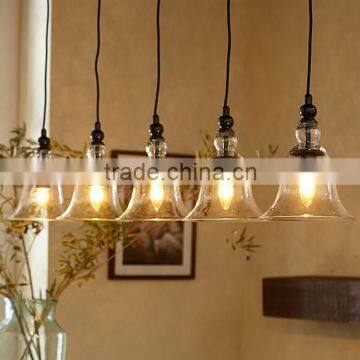 11.28-2 RUSTIC GLASS 5-LIGHT PENDANT provide generous illumination over a bar or long dining table