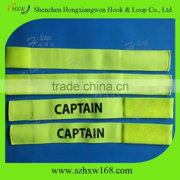 Adjustable captain arm band with hook and loop closure