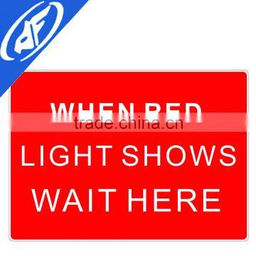 Reflective adhesive When red light shows wait here traffic sign