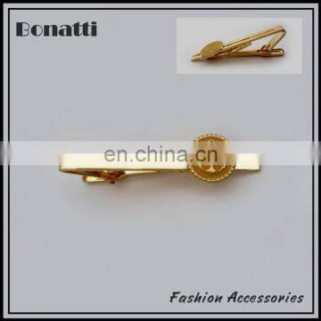 golden tie bar with enamel logo