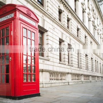 antique red painted metal street telephone box