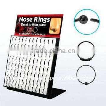 Display board with 96 pcs. of black plated sterling silver nose hoops with and without ball