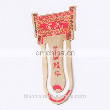 orange metal bookmark and book clip