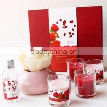 Glass cups filled with candle wax and glass bottle of fragrance oil diffuser