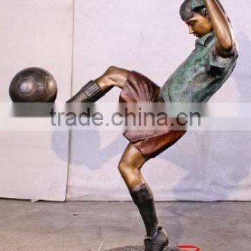 bronze boy sculpture playing football outdoor decor