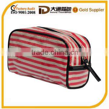 Small clear coated cosmetic bag featuring a coated stripe pattern zippered placket along the top