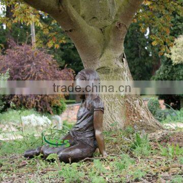 Bronze angel sitting under tree statue