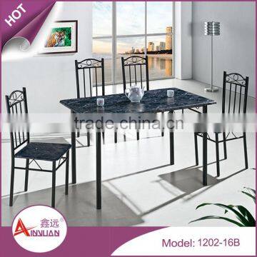 Durable custom color round side design black wooden pvc top dining table with 4 chairs