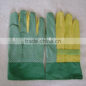 Green PVC impregnated glove with white PVC dots