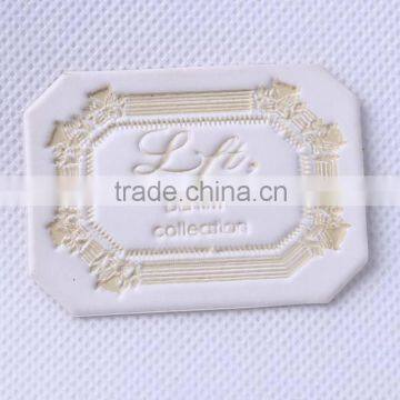 White jeans leather label