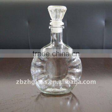 round clear glass wine bottle