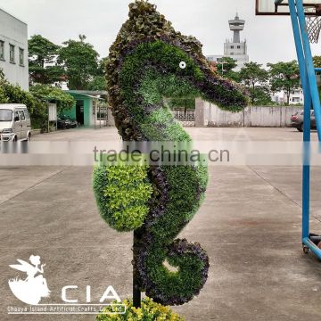 Fake green sculpture animal boxwood topiary hippocampus