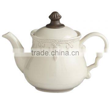 Embossed stoneware teapot with raised lace-like trim