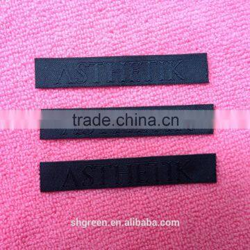 Straight Cut Black Background Black Logo Woven Label