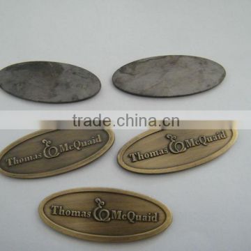 brass oval badge