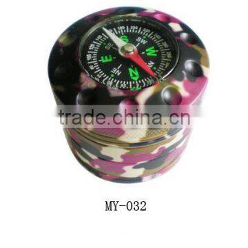 around metal cigarette grinder with compass