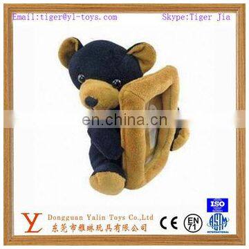 Plush bear holding love photo frame