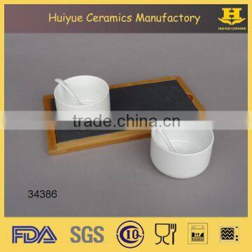 ceramic bowl with spoon with bamboo tray