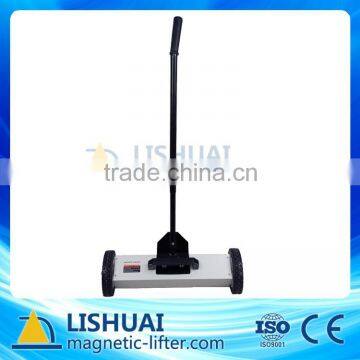 Magnetic floor sweeper with handle release