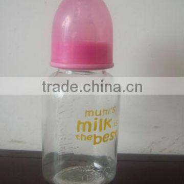 Glass baby bottle with red cap