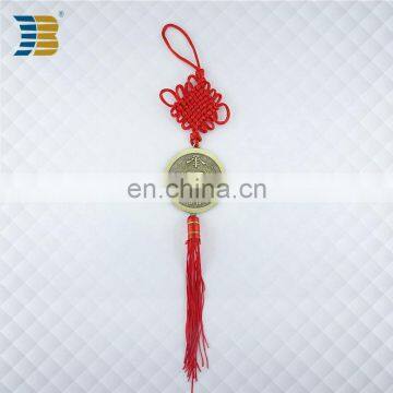 bronze coin with red Chinese knot charm