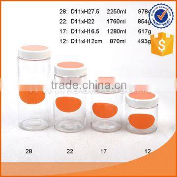 clear glass storage jar with orange board