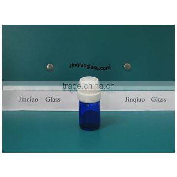 small cobalt blue glass cosmetic bottle