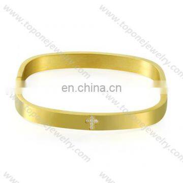 Square stainless steel gold plated bangle with cross engraved CZ stone