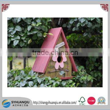 Colorful wooden bird cage with flower pasted