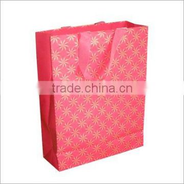 shopping paper bag with red ribbon