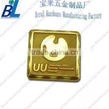 Gold plated metal scutcheon for bags