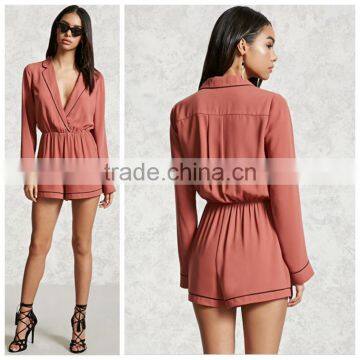 Lady Woven surplice neckline notched lapels an elasticized waist long sleeves a center-back pleat and contrast piping romper