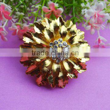 Fancy gold bow brooch with big rhinestone