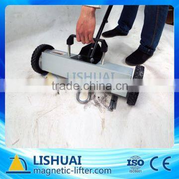 Magnetic road sweeper with handle release