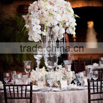 Centerpiece flower arrangement with white orchids cascading over the side, dripping crystal beads and roses