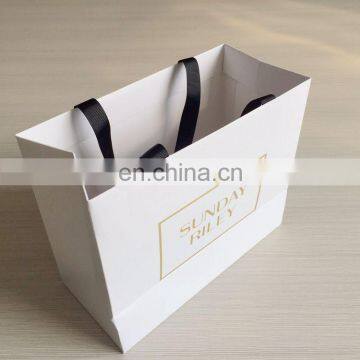 Hot sale luxury white foil logo black grosgrain ribbon shopping paper bag