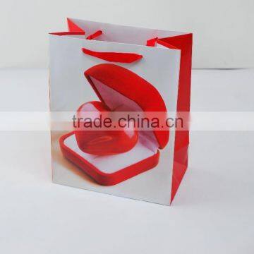 Custom red heart style paper bag for packing small gifts with ribbon handle made in china supplier and manufacture