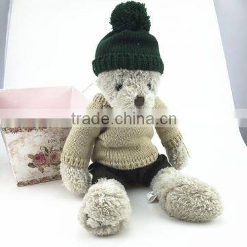 The Teddy Bear Wearing green knitted hat and brown knitted T-shirt