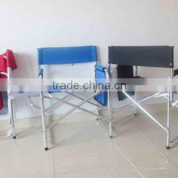 Portable aluminum or steel director chair with side table and bags.