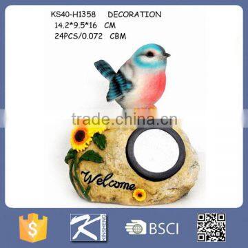 Resin birds standing on solar light for garden decoration