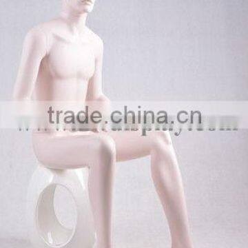 Realistic male mannequins in sitting pose