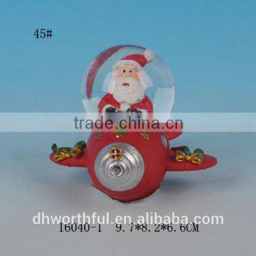 Red resin santa snow globe for christmas day